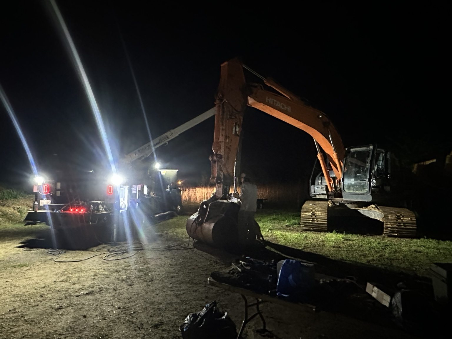 Excavator repair at a nighttime jobsite